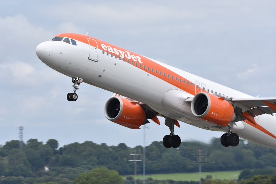 Dynamic shot of an EasyJet Airbus A320 taking off at Bristol Airport, capturing flight power and motion.